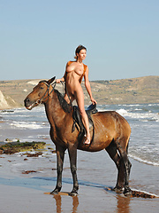 Suzanna A horse-back rides naked on the beach